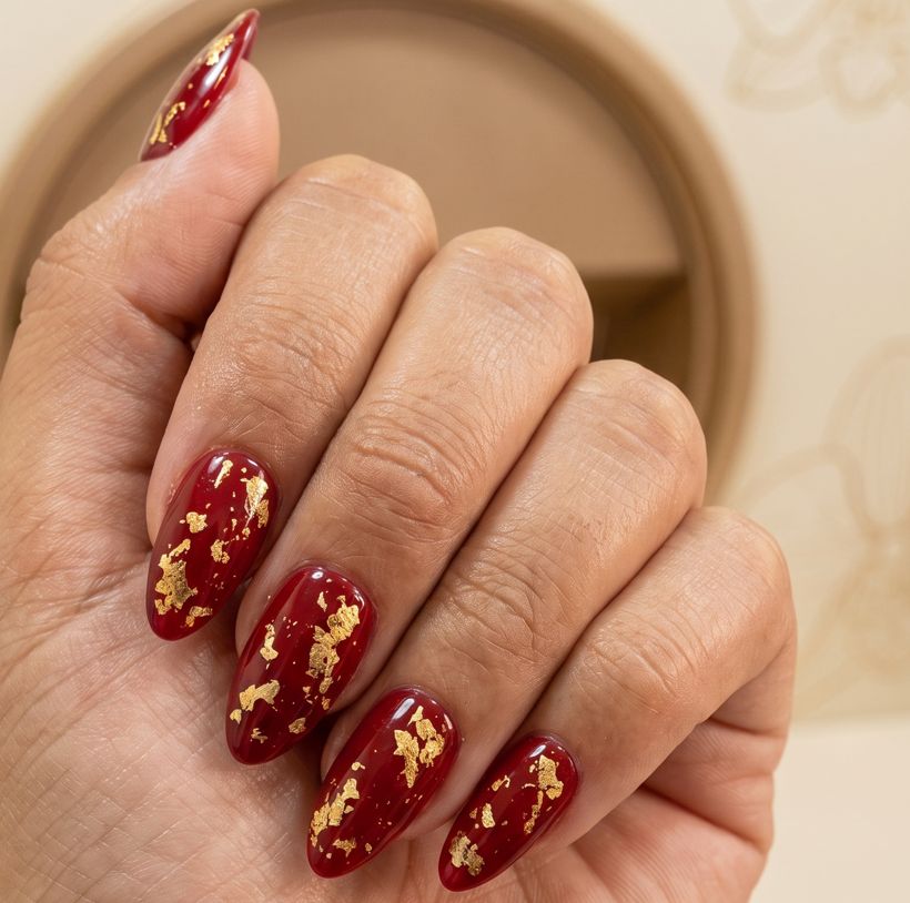 Uñas rojas con hoja dorada